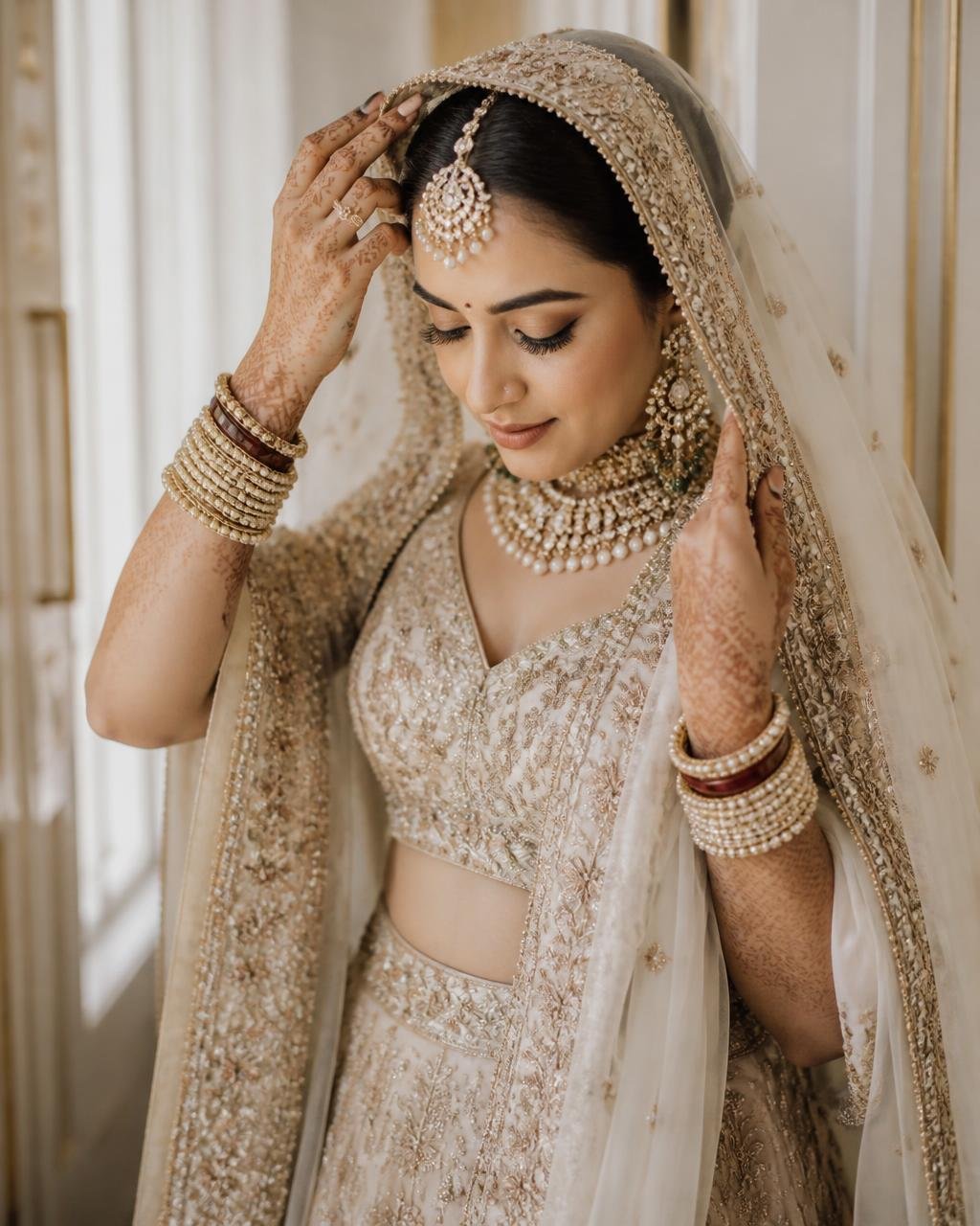 Bride adjusting her dupatta in soft daylight