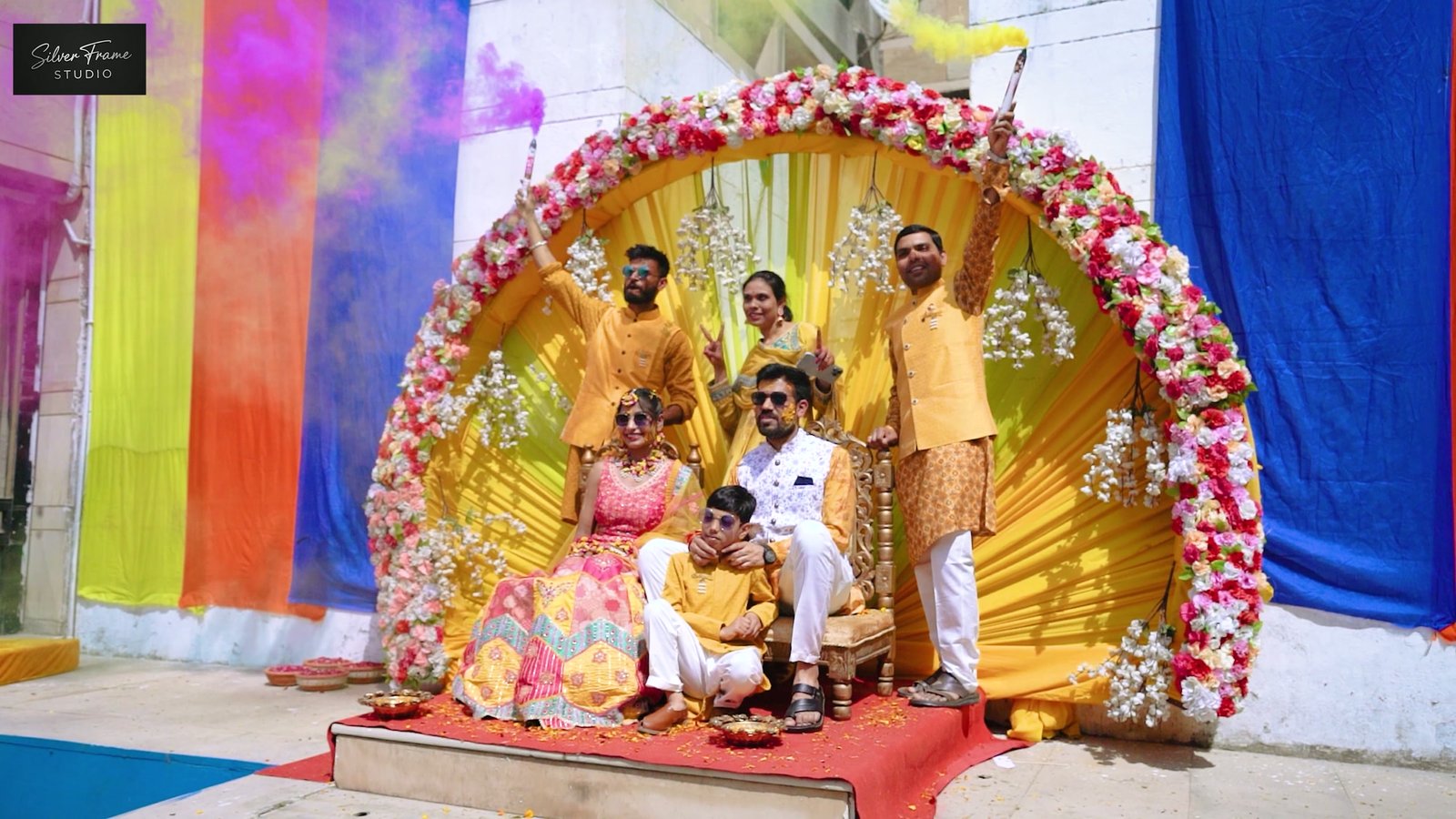 Akash and Pragya seated at their floral haldi mandap