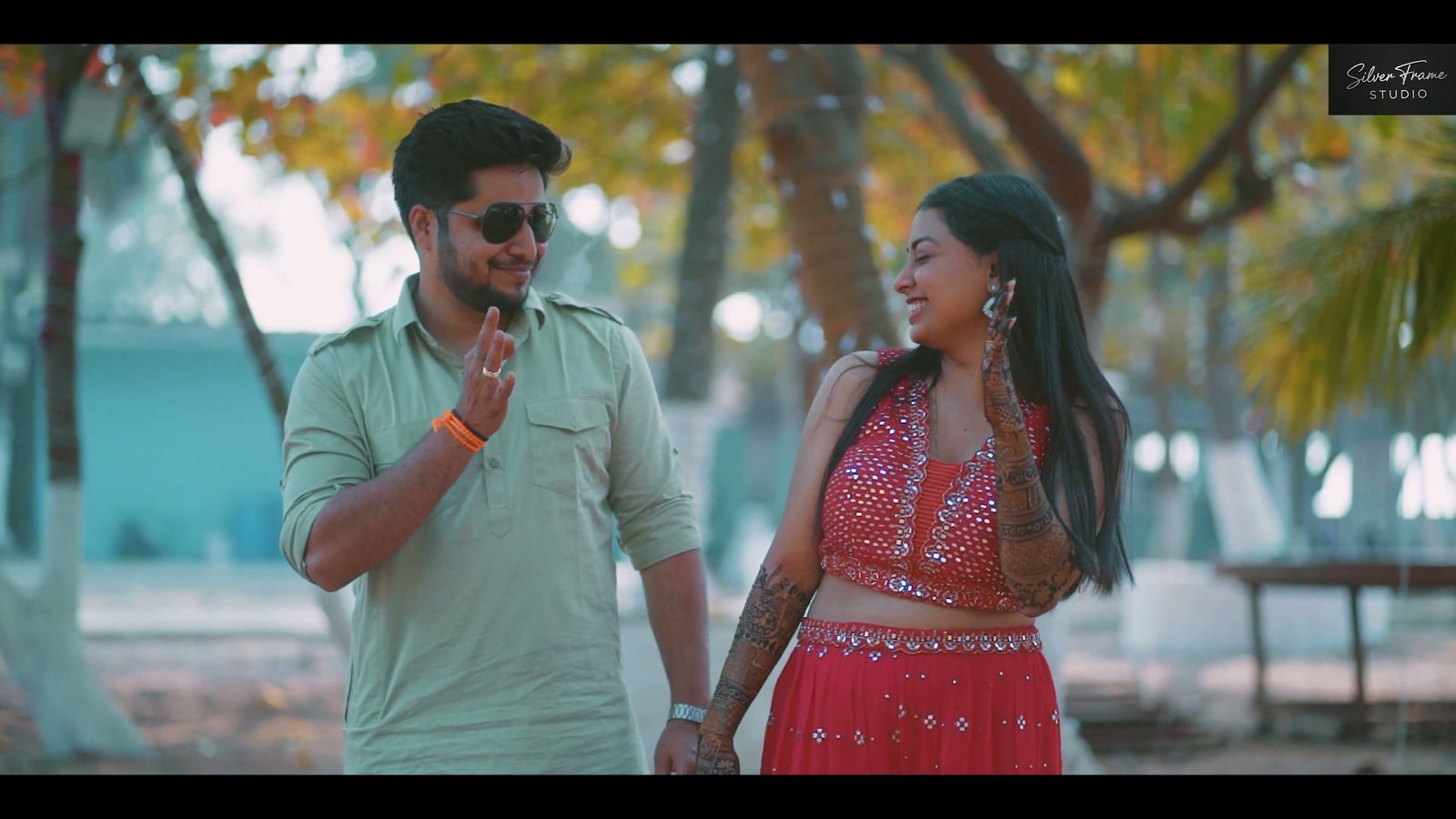 Annu and Sachin walking together under palm trees